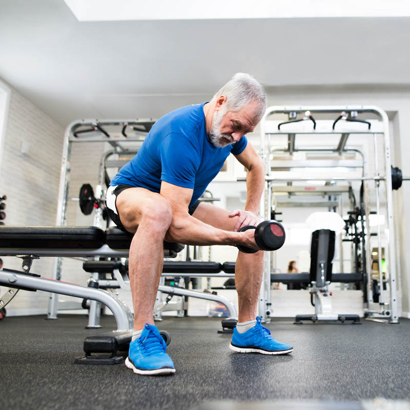 Senior,Man,In,Sports,Clothing,In,Gym,Working,Out,With